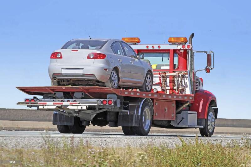 gray car on tow truck