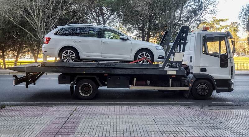white car on tow truck